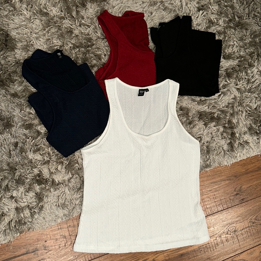 New Size L set of 4 Tank Tops. Black, White, Navy, Burgundy. Never worn